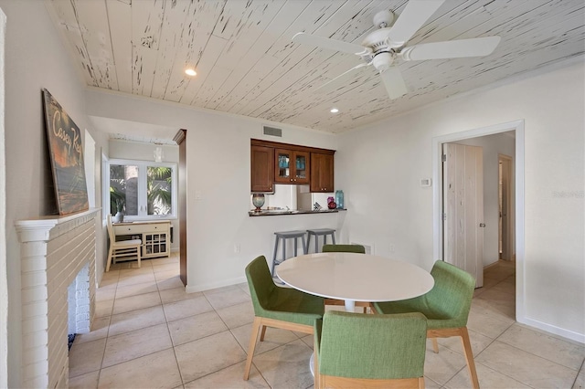 tiled dining area with wooden ceiling and ceiling fan