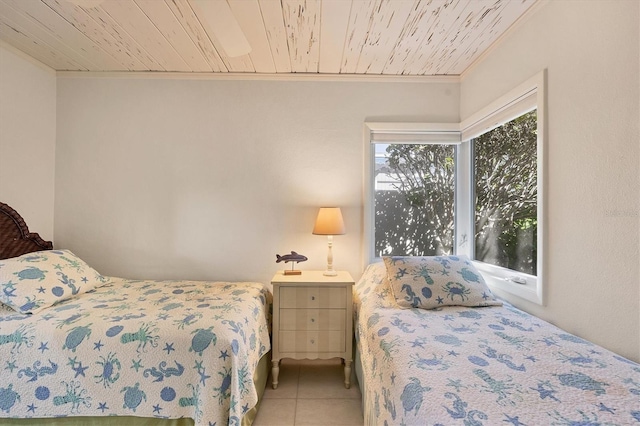 bedroom with wood ceiling, crown molding, and light tile patterned floors