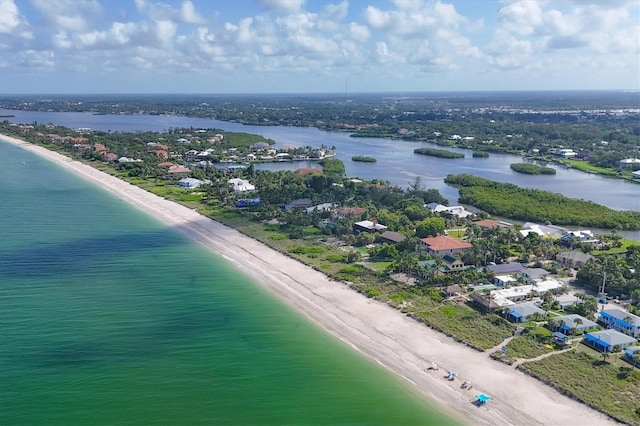 bird's eye view with a water view and a beach view