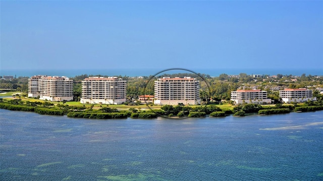 birds eye view of property with a view of city and a water view