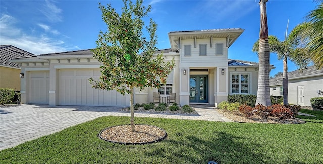 view of front of property featuring a garage and a front yard