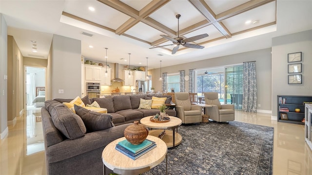 tiled living room with beam ceiling, coffered ceiling, and ceiling fan