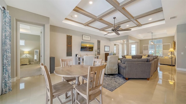 tiled dining space with beamed ceiling, coffered ceiling, and ceiling fan