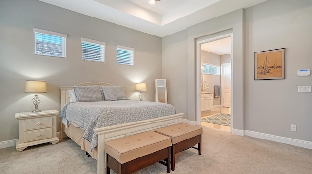 carpeted bedroom featuring ensuite bathroom