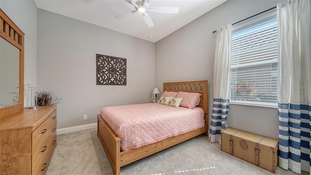 bedroom featuring lofted ceiling, light colored carpet, and ceiling fan