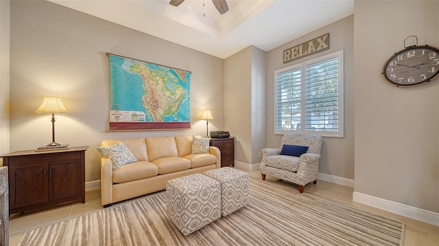 sitting room featuring light tile patterned flooring and ceiling fan