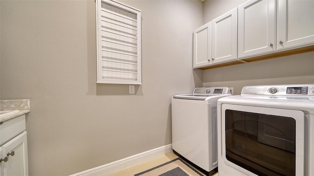 washroom featuring cabinets and washer and dryer