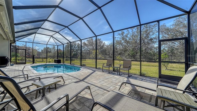 view of swimming pool featuring a yard, a lanai, and a patio