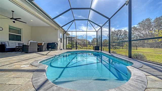 view of swimming pool featuring ceiling fan, a lanai, and a patio