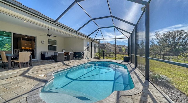 view of pool with a patio, a lanai, an outdoor hangout area, and ceiling fan