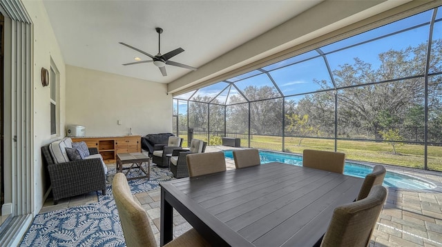 view of patio / terrace featuring ceiling fan, an outdoor living space, and a lanai