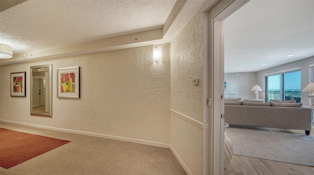 corridor featuring hardwood / wood-style flooring and a textured ceiling