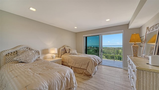 bedroom with access to outside and light wood-type flooring