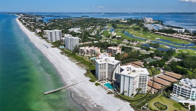 drone / aerial view featuring a water view and a beach view