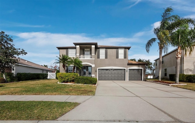 view of front facade featuring a garage, a balcony, and a front yard