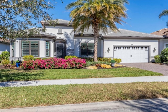 mediterranean / spanish home with a garage and a front yard