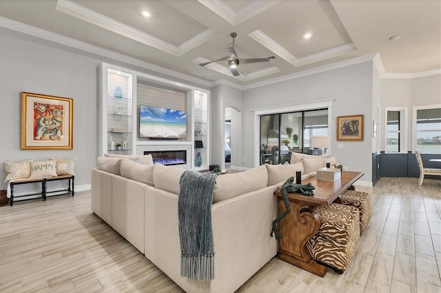 living room featuring coffered ceiling, ceiling fan, light hardwood / wood-style floors, crown molding, and beam ceiling