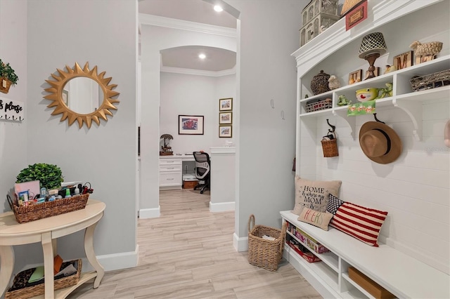 mudroom featuring ornamental molding and light wood-type flooring