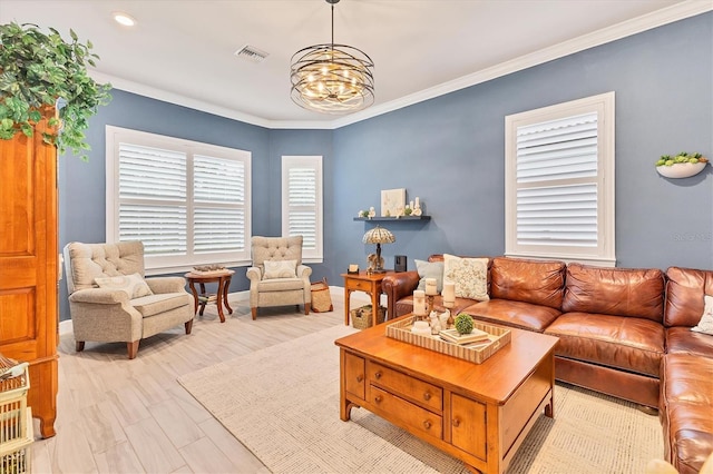 living room with crown molding, a chandelier, and light wood-type flooring