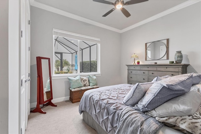 carpeted bedroom with ornamental molding and ceiling fan