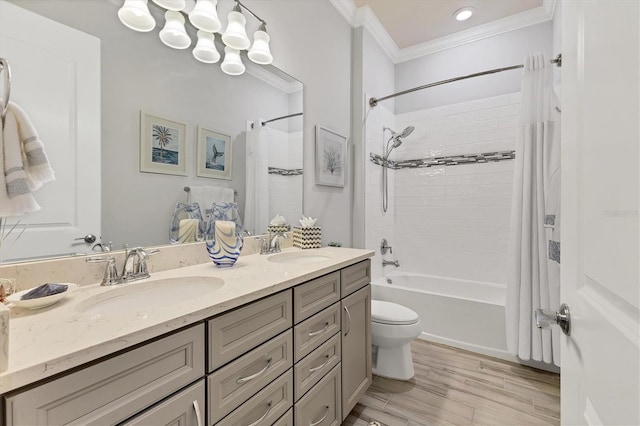 full bathroom with crown molding, hardwood / wood-style flooring, shower / bath combo, vanity, and toilet