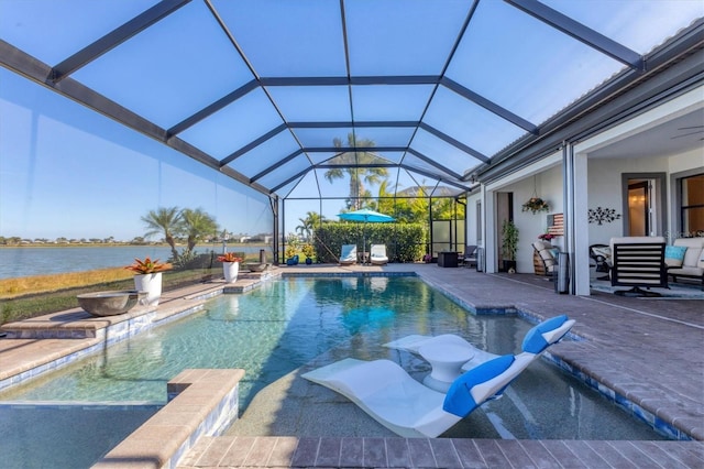 view of swimming pool with a water view, a patio, and glass enclosure