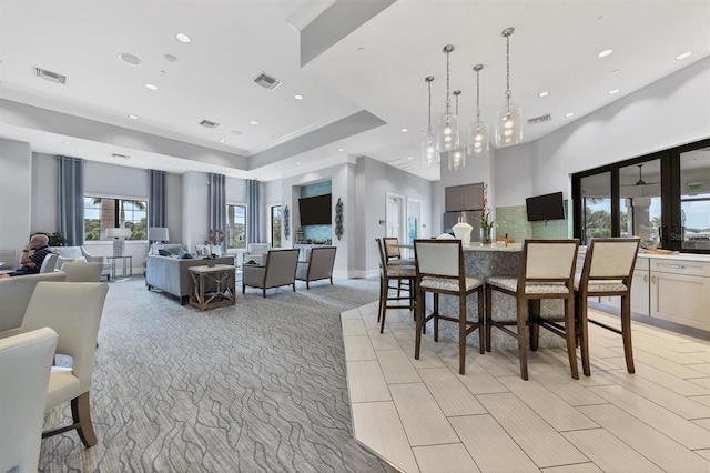 dining area featuring a raised ceiling