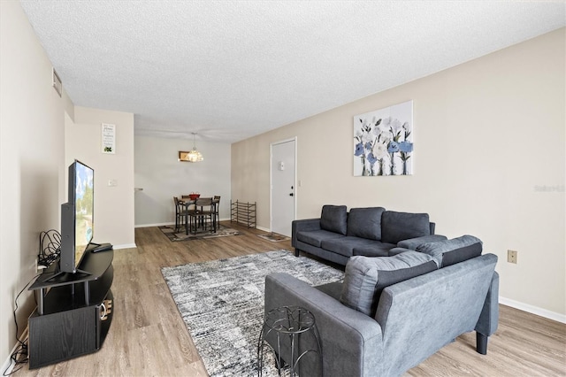 living room with hardwood / wood-style floors and a textured ceiling