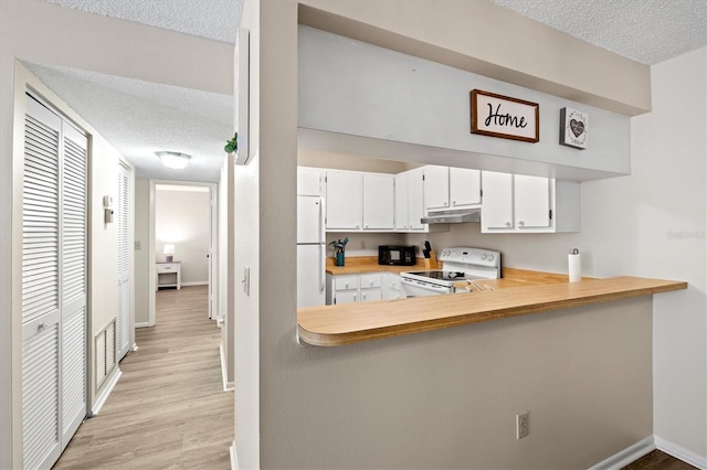 kitchen featuring white cabinetry, white appliances, a textured ceiling, and light wood-type flooring