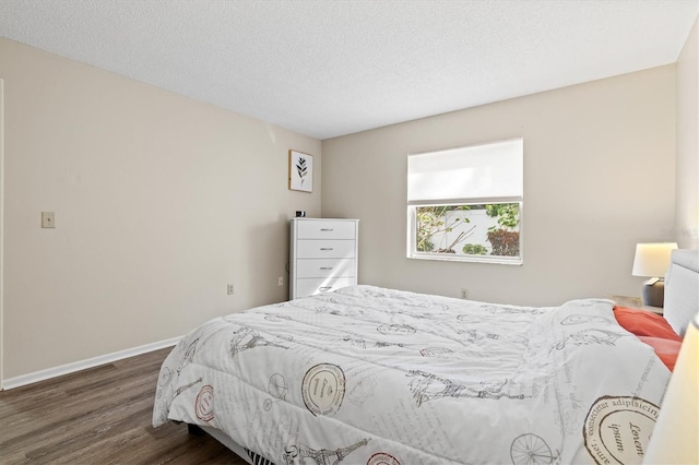 bedroom featuring a textured ceiling and dark hardwood / wood-style flooring