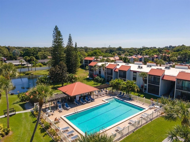 view of swimming pool with a water view and a patio