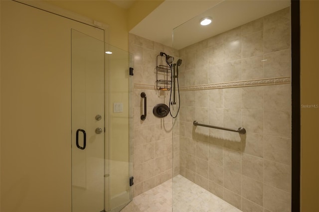 bathroom with a shower with door