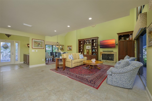 tiled living room featuring baseboards, a fireplace, and recessed lighting