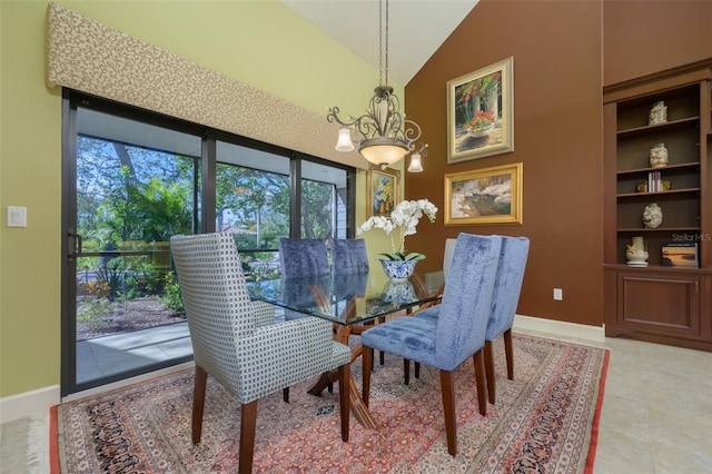 dining room with high vaulted ceiling, light tile patterned flooring, an inviting chandelier, and baseboards