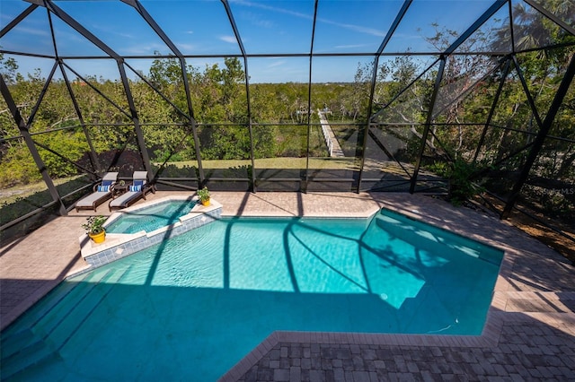 view of swimming pool with a patio, a lanai, and a pool with connected hot tub