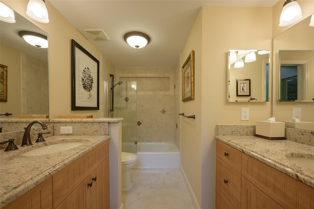 bathroom with toilet, two vanities, a sink, and visible vents