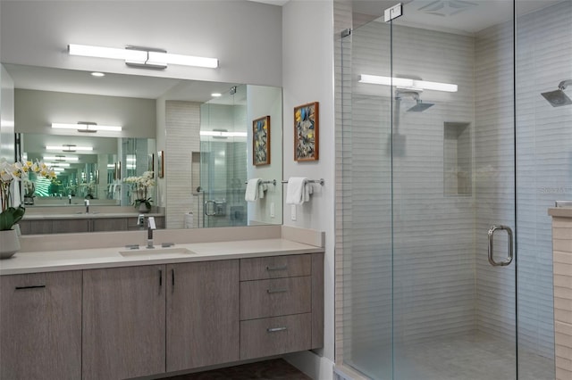 bathroom featuring vanity and an enclosed shower