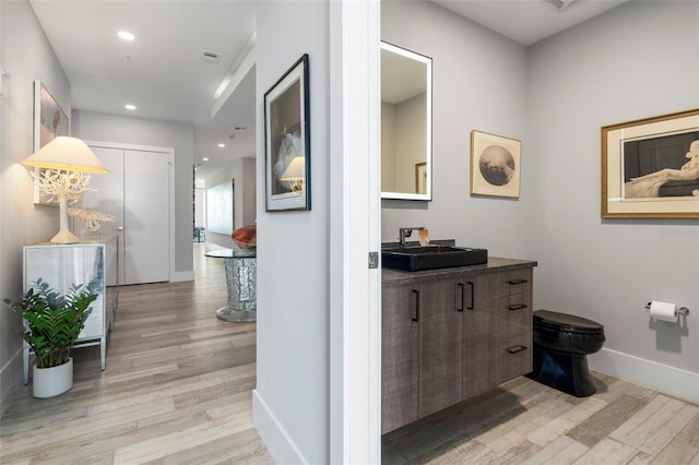 corridor featuring light hardwood / wood-style floors and sink