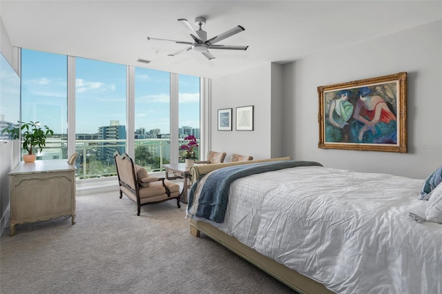 bedroom featuring ceiling fan, light colored carpet, and floor to ceiling windows