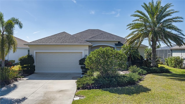 single story home with a garage and a front lawn