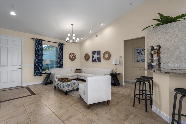 tiled living room with an inviting chandelier and lofted ceiling