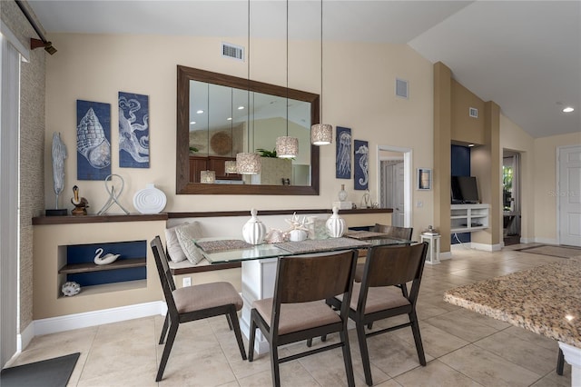 tiled dining area with high vaulted ceiling