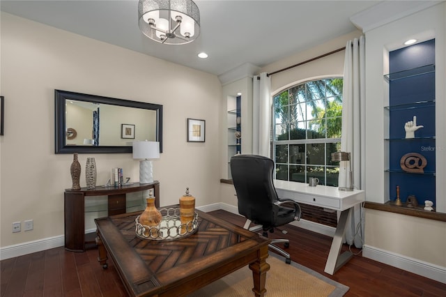 office space with a notable chandelier, dark wood-type flooring, and built in features