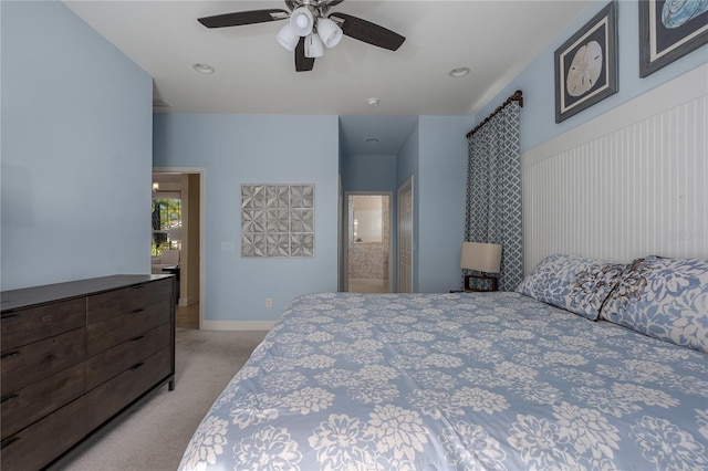 bedroom with ceiling fan and light carpet