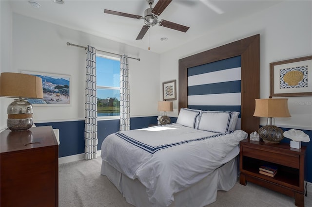 bedroom with ceiling fan and light colored carpet