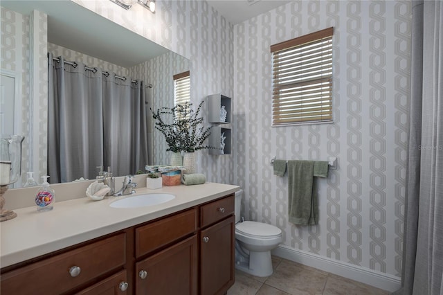 bathroom featuring vanity, tile patterned floors, and toilet