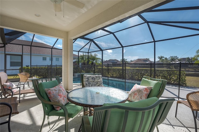 view of patio with ceiling fan and a lanai