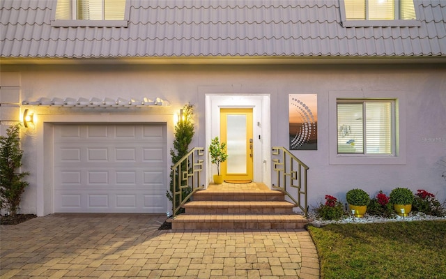 doorway to property with a garage