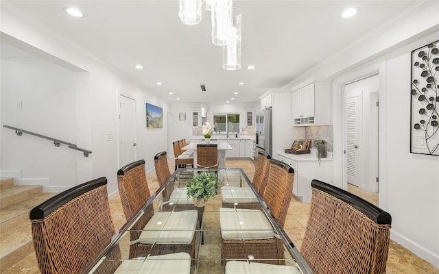 tiled dining room featuring crown molding