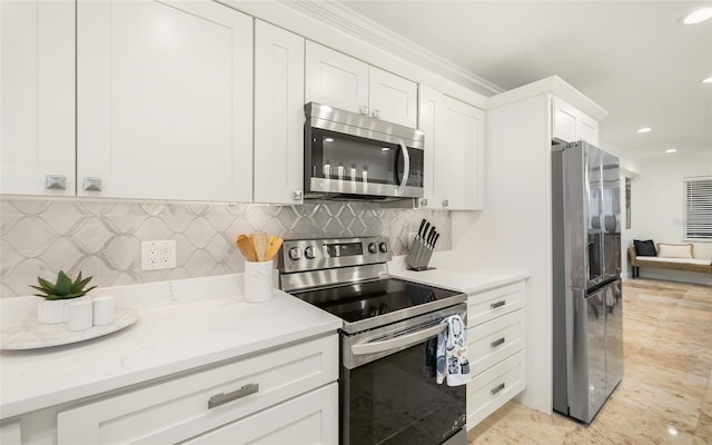 kitchen featuring tasteful backsplash, stainless steel appliances, light stone countertops, and white cabinets